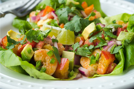 Grilled Thai chili shrimp served in lettuce cups with avocado, red onion, and slaw