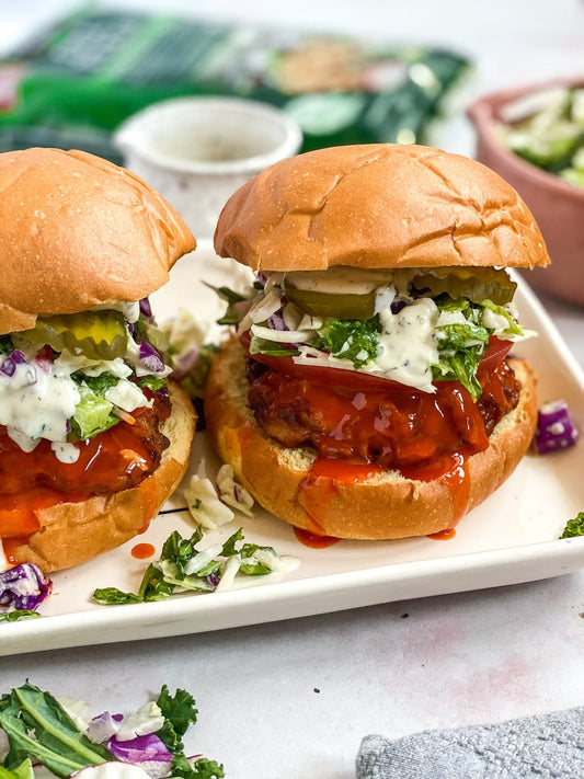 Mini buffalo chicken sliders with ranch slaw and pickles on toasted slider buns